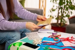 woman do card making with various supplies