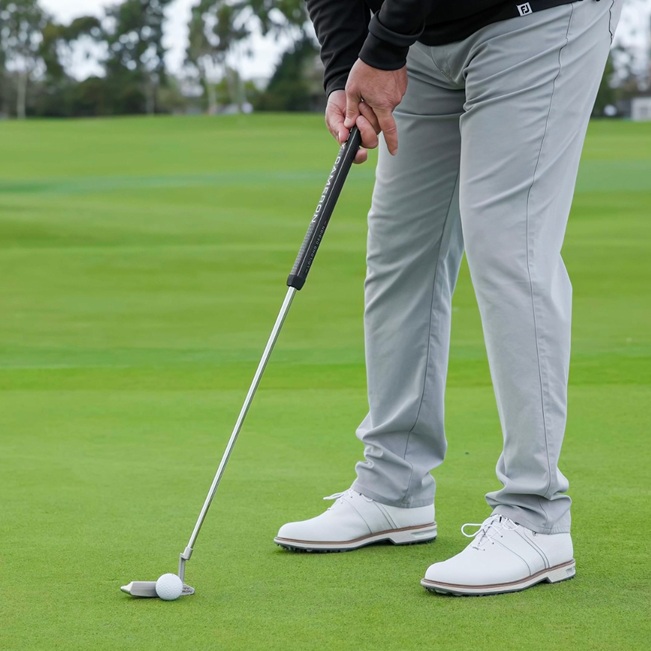 a person wearing gray golf pants for men