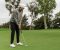 person playing golf on a field with black pants