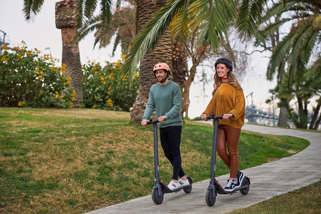 man and woman driving Segway Ninebot kickscooter